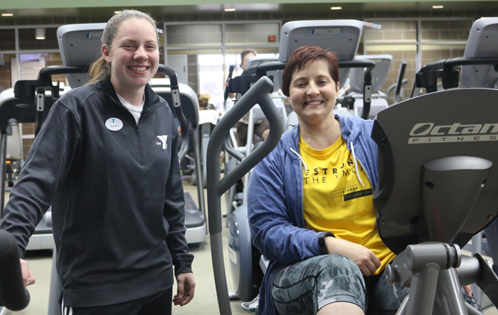 Jennifer R. is now a member at the Earlywine YMCA. She has been fighting cancer for more than 9 years. Amaris S., a staff member, demonstrates how to use the xRide xR6000 workout boosters.