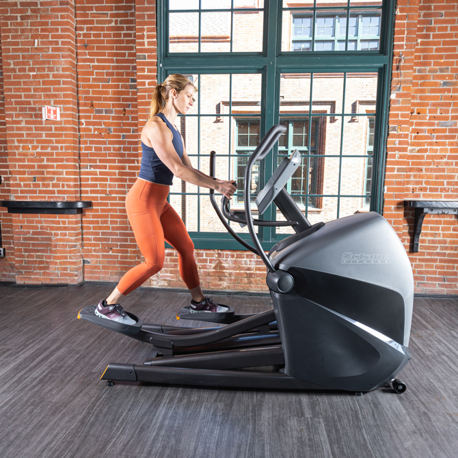 Woman working out on the XT3700 standing elliptical - side view