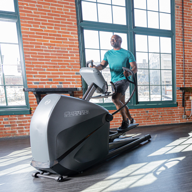 Man working out on the XT3700 standing elliptical - front view