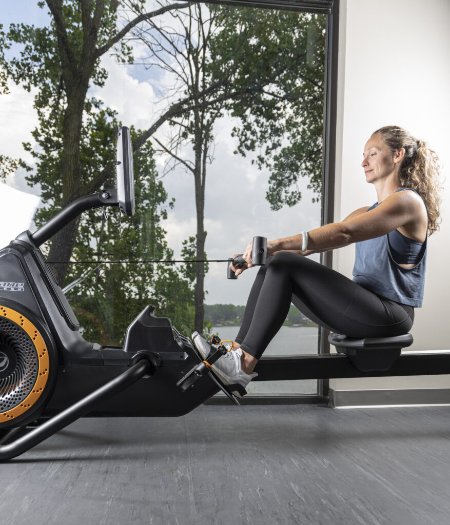 Woman using Octane Ro rower, knees bent