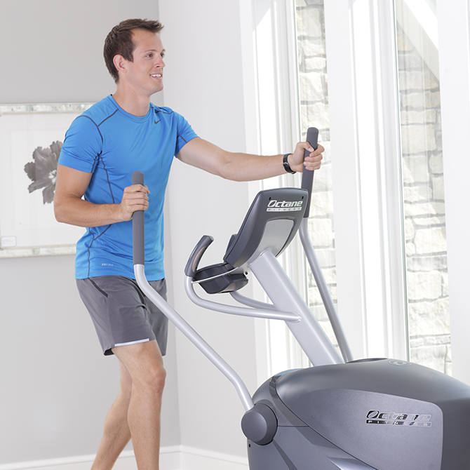 Man working out at home on the Q35x standing elliptical