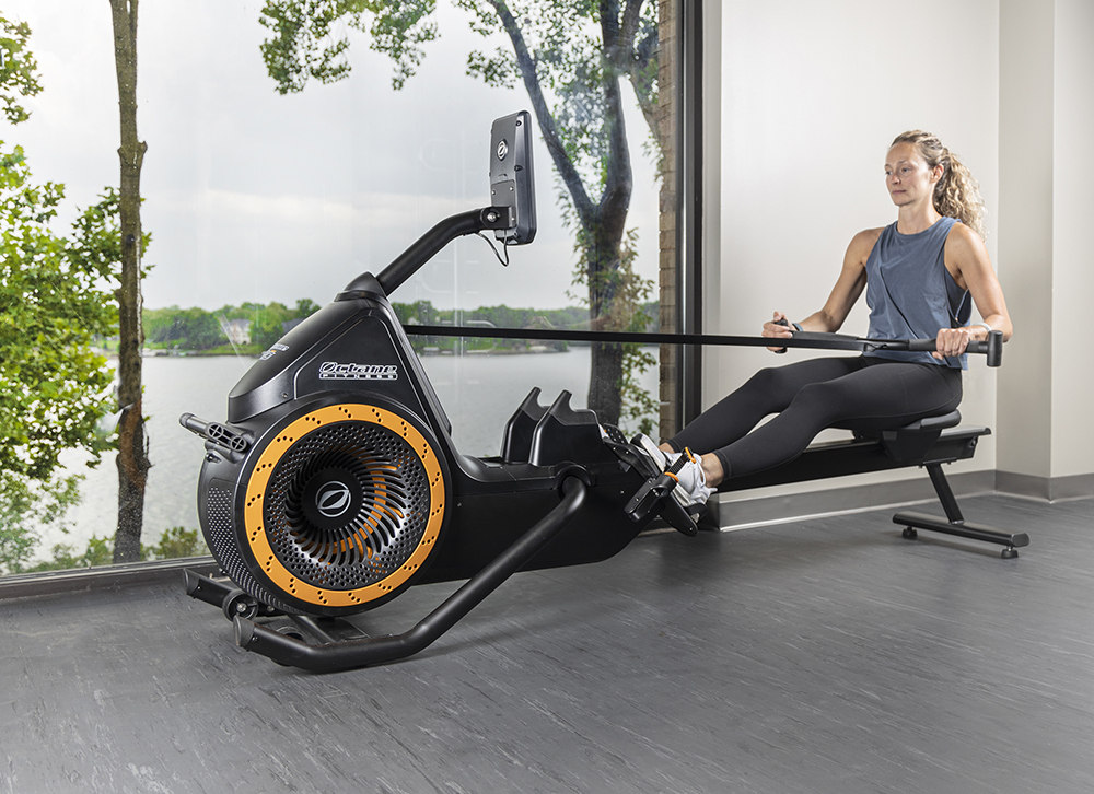 Woman using Octane Ro rower, legs extended