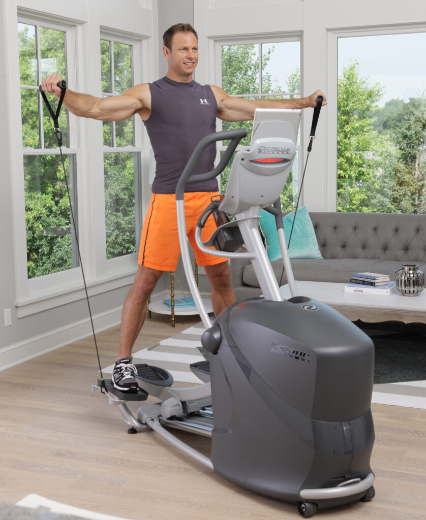 Man using the CROSS CIRCUIT+ Kit while working out on the Q37xi standing elliptical