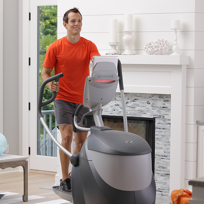 Man working out at home on the Q47xi standing elliptical