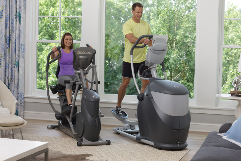 Woman and man working out together on Octane residential fitness equipment.